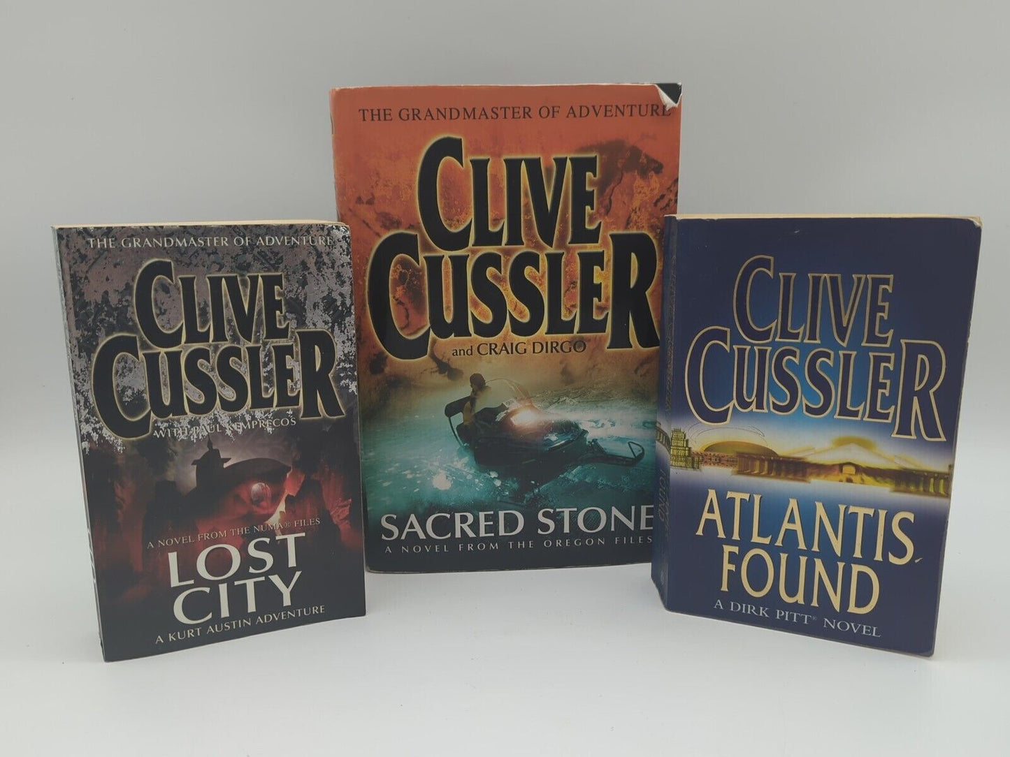 3x Clive Cussler book bundle Sacred Stone (Hardcover), Lost City, Atlantis Found